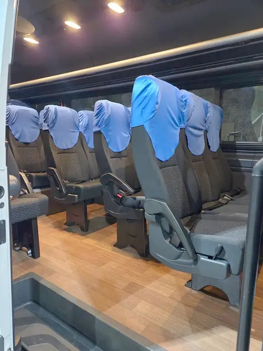 Poltronas com capas azuis e luzes no teto de uma van